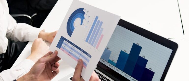 Business professionals discussing data charts and graphs in a modern office setting.
